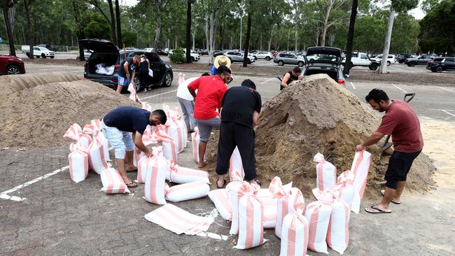 Brisbane residents pictured collecting sandbags from the Boondall sandbagging location Picture David Clark