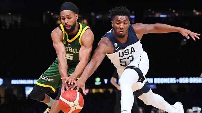 Patrick Mills of the Boomers and Donovan Mitchell of the USA compete for the ball.