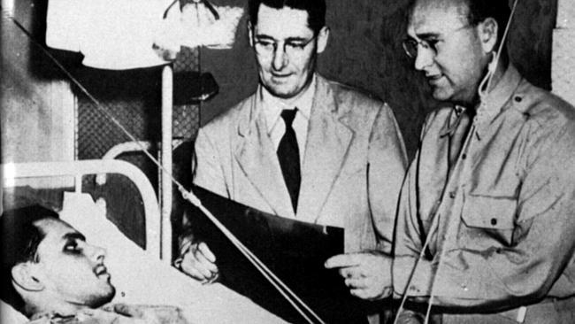  SA scientist Professor Howard Florey (later Lord Florey) (c) examining wounded solider undergoing penicillin treatment in American military hospital in New York, USA 1944. 1940s historical Picture: Supplied 