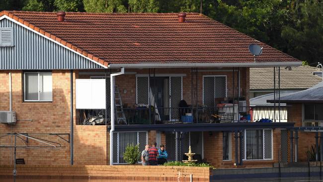 Residents watch the overflowing Clarence River from their backyard in Grafton. Photo: SAEED KHAN / AFP