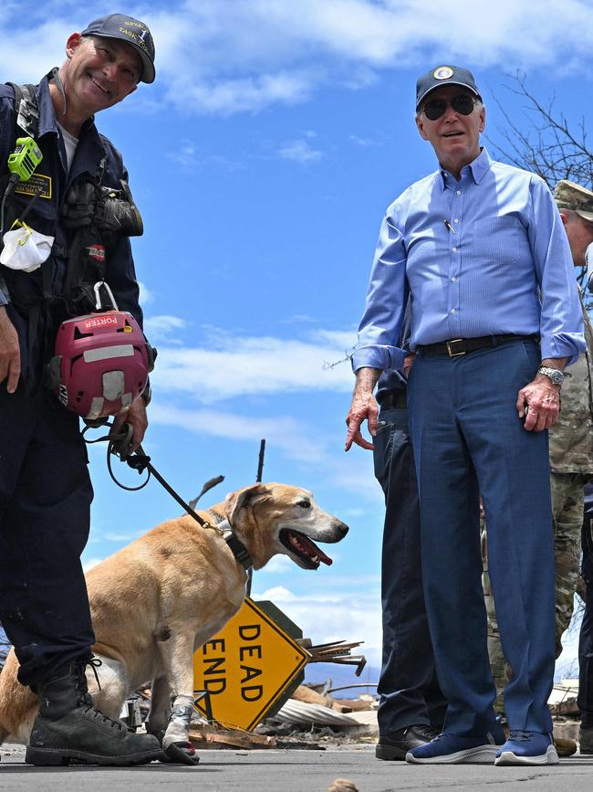 ‘Hot ground’: US President Joe Biden jokes about the protective boots being worn by a cadaver dog, which has been scouring the scorched earth searching for dead fire victims. Picture: AFP