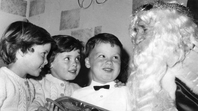 Father Christmas with the Gill triplets — Craig, Tracey and Dianne — at Marion in 1969.