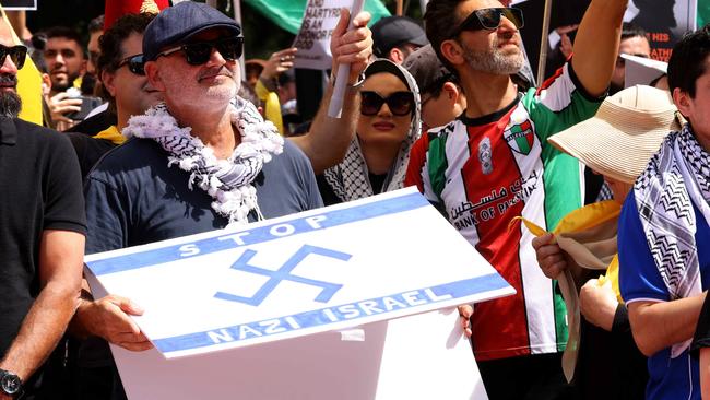 Al Yazbek pictured holding Nazi swastika superimposed on an Israeli flag at a protest in Hyde Park in Sydney's CBD. Picture: NewsWire / Damian Shaw