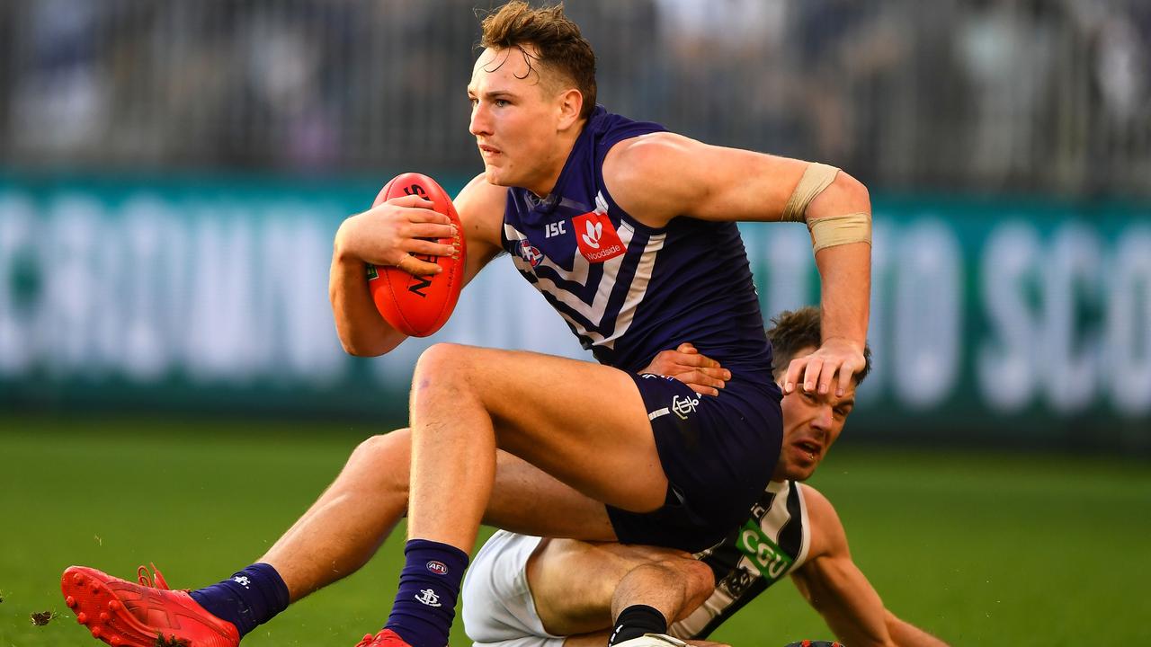 PERTH, AUSTRALIA - AUGUST 25: Brennan Cox of the Dockers is tackled by Levi Greenwood of the Magpies during the 2018 AFL round 23 match between the Fremantle Dockers and the Collingwood Magpies at Optus Stadium on August 25, 2018 in Perth, Australia. (Photo by Daniel Carson/AFL Media/Getty Images)