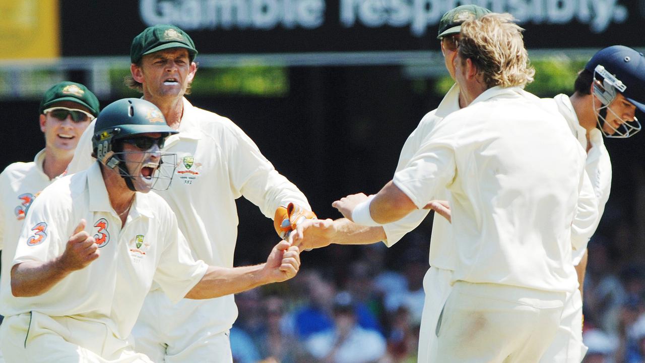 Mike Hussey and Shane Warne celebrate a wicket for Australia.