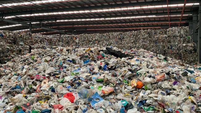 Recycling waste is piled sky-high in Melbourne warehouses.