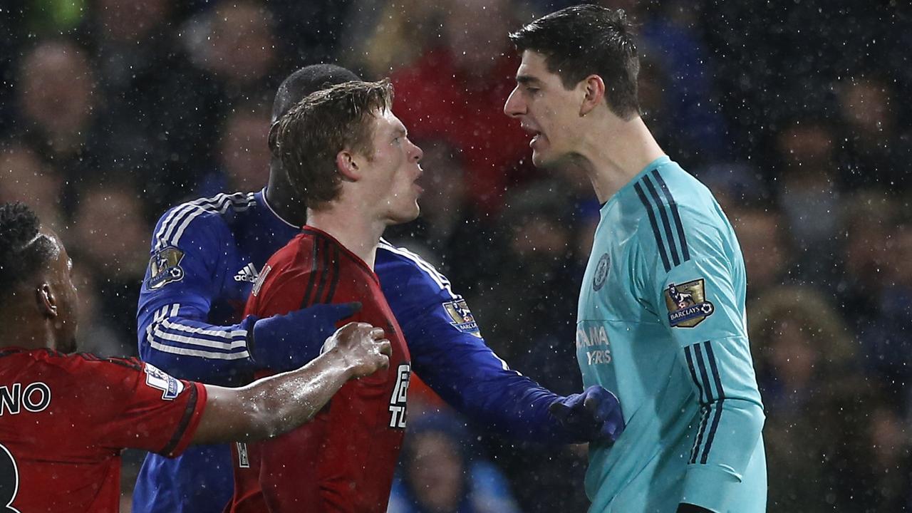 Chelsea's Belgian goalkeeper Thibaut Courtois (R) clashes with West Bromwich Albion's Irish midfielder James McClean during the English Premier League football match between Chelsea and West Bromwich Albion at Stamford Bridge in London on January 13, 2016. AFP PHOTO / IAN KINGTON RESTRICTED TO EDITORIAL USE. NO USE WITH UNAUTHORIZED AUDIO, VIDEO, DATA, FIXTURE LISTS, CLUB/LEAGUE LOGOS OR 'LIVE' SERVICES. ONLINE IN-MATCH USE LIMITED TO 75 IMAGES, NO VIDEO EMULATION. NO USE IN BETTING, GAMES OR SINGLE CLUB/LEAGUE/PLAYER PUBLICATIONS.