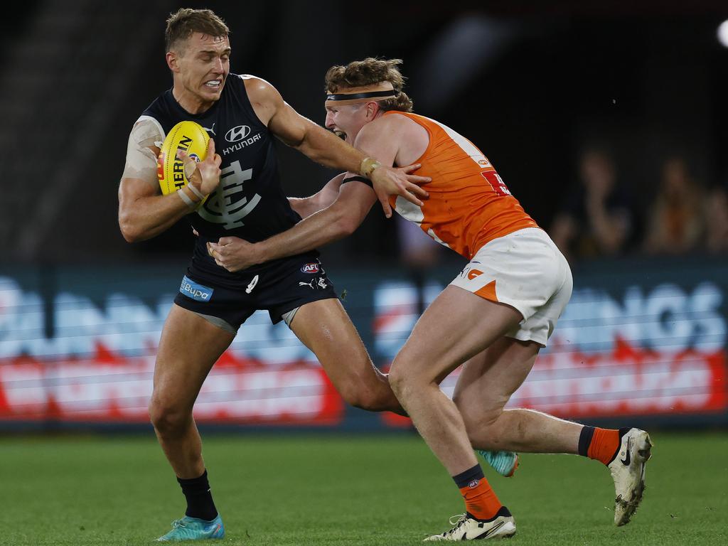 Patrick Cripps tries to bust out of a tackle from Tom Green. Picture: Michael Klein