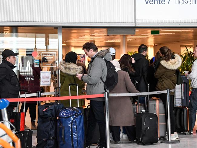 Travellers queue for information in France after President Trump’s shock decision. Picture: Bertrand GUAY / AFP.