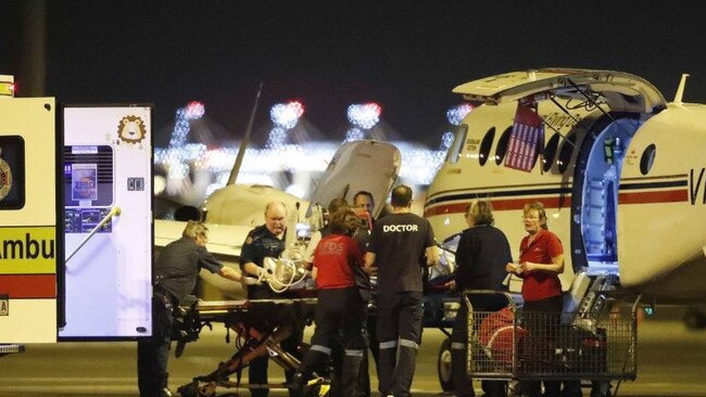 A patient is transferred from a RFDS plane to a waiting ambulance in Brisbane. Picture: Josh Woning/AAP