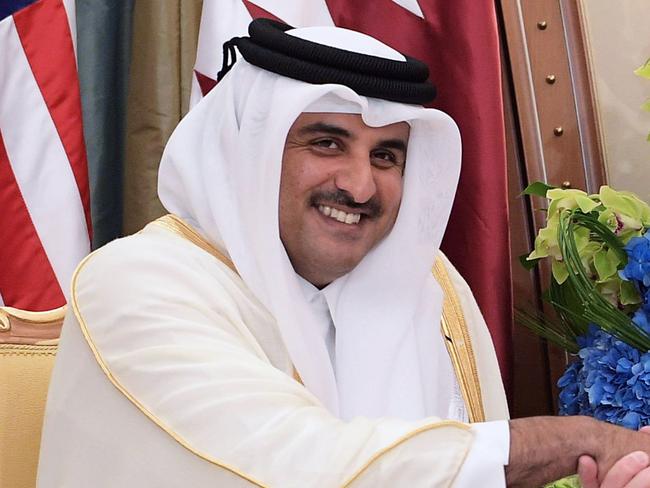 (FILES) This file photo taken on May 21, 2017 shows US President Donald Trump (R) shaking hands with Qatar's Emir Sheikh Tamim Bin Hamad Al-Thani, during a bilateral meeting at a hotel in the Saudi capital Riyadh. In a series of morning tweets, President Donald Trump threw Washington's relations with Doha into deep crisis on June 6, 2017 and raised doubts about the future of the largest US air base in the Middle East. Trump publicly accused key regional ally Qatar of funding extremism, while tacitly backing a blockade of the emirate, home to the Al-Udeid Air Base near Doha where around 10,000 US military personnel are stationed.  / AFP PHOTO / MANDEL NGAN