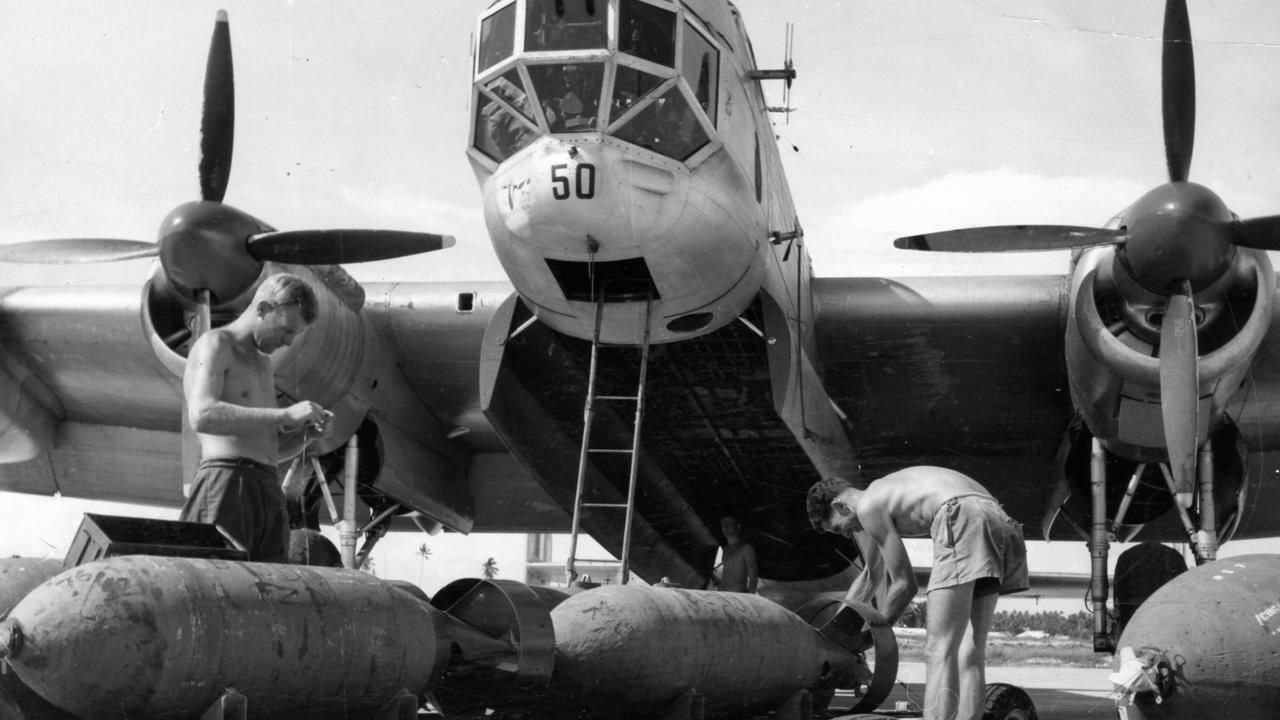 RAAF armourers loading 1000 pound bombs into Lincoln aircraft at RAAF Air Base, Butterworth, Penang.