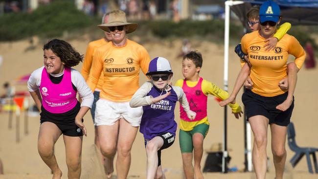 North Entrance competitor Greyson Broadhurst (middle) in action during the beach sprint. Picture: Troy Snook