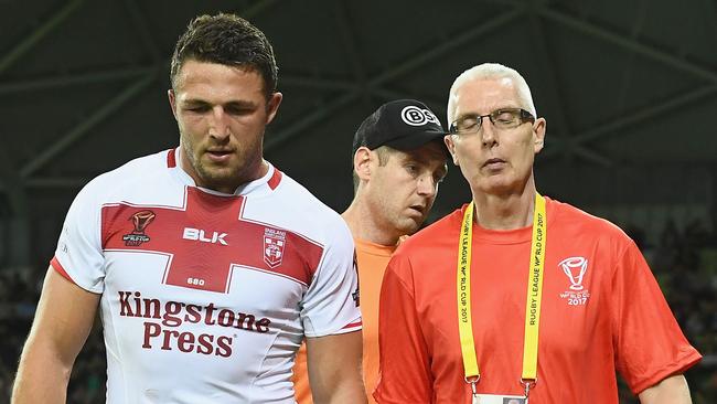 Sam Burgess leaves the field after injuring his knee.