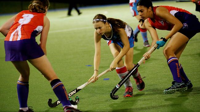 from the Cairns Hockey A Grade Women's match between the Cairns Saints and Trinity Stingers. Saints’ Sophie Glover takes on Stingers' Kaitlyn Broad and Sophie Gilligan. PICTURE: STEWART MCLEAN