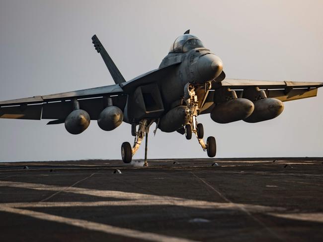 This July 31, 2016 US Navy handout photo shows an F/A-18F Super Hornet preparing to make an arrested landing on the flight deck of the aircraft carrier USS Dwight D. Eisenhower (CVN 69) (Ike) in the Arabian Gulf after a mission in support of Operation Inherent Resolve. The US-led military campaign against the Islamic State group enters its third year. Billions of dollars, more than 14,000 air strikes and thousands of deaths after its launch, the fight shows no sign of ending and, despite several important victories, highlights the limits of fighting a war mainly from the skies. / AFP PHOTO / US Navy / Petty Officer 3rd J. Alexander DELGADO / RESTRICTED TO EDITORIAL USE - MANDATORY CREDIT "AFP PHOTO / US NAVY / PO3 J. ALEXANDER DELGADO" - NO MARKETING - NO ADVERTISING CAMPAIGNS - DISTRIBUTED AS A SERVICE TO CLIENTS