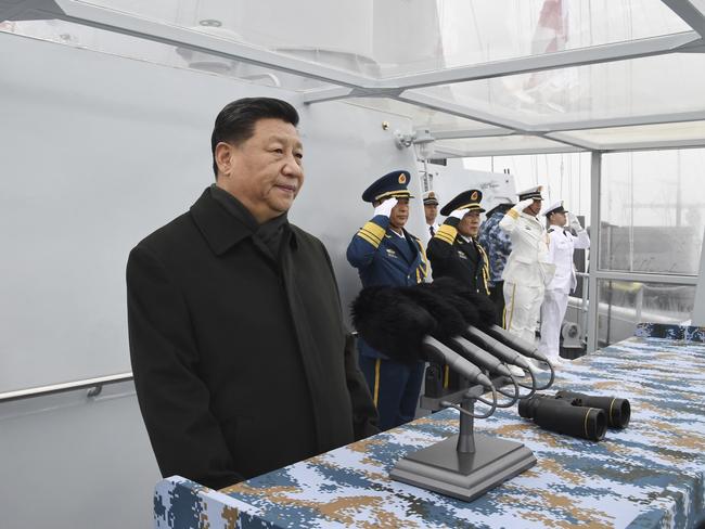 In this photo released by China's Xinhua News Agency, Chinese President Xi Jinping reviews a naval parade with Chinese and foreign military ships held in commemoration of the 70th anniversary of the Chinese People's Liberation Army (PLA) Navy in the sea near Qingdao in eastern China's Shandong Province, Tuesday, April 23, 2019. (Li Gang/Xinhua via AP)