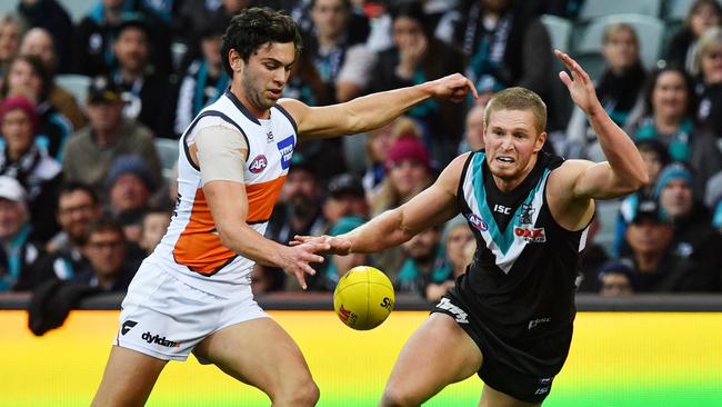 Tim Taranto of the Giants and Tom Clurey of the Power during the Round 18 AFL match between the Port Adelaide Power and the Greater Western Sydney (GWS) Giants at Adelaide Oval in Adelaide, Sunday, July 22, 2018. (AAP Image/David Mariuz) NO ARCHIVING, EDITORIAL USE ONLY