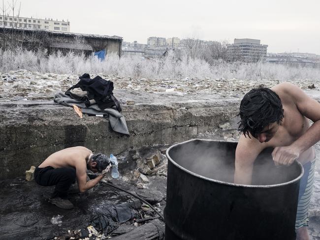 Afghan refugees wash theirself outside of a warehouse in Belgrade. Up to 1500 migrants are trying to survive the freezing Serbian winter in a crumbling building with broken windows, no electricity, no heating, or water. They are surviving without sanitation and in a sub-zero winter. Picture: Francesco Pistilli/World Press Photo