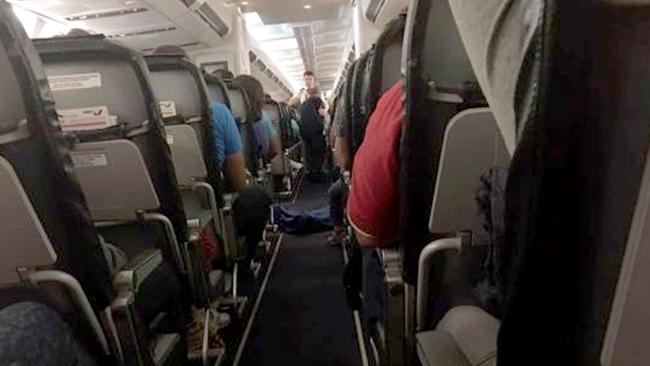 Passengers took photos of the woman’s body on the floor of the cabin after she died mid-flight. Picture: CEN/australscope