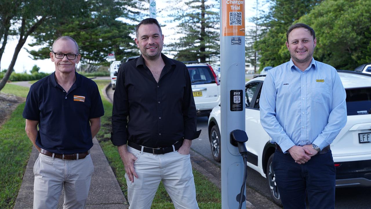 Essential Energy chief commercial officers Justin Hillier, EVX chief executive Andrew Foster and Wagners utility product lead James Lorrimer in front of the trial street-light EV charger in Port Macquarie, New South Wales. It was created as a collaboration between Essential Energy, Toowoomba firm Wagners and EVX.