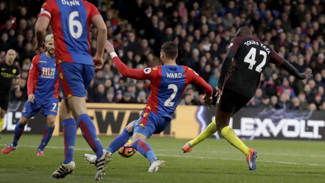 Manchester City's Yaya Toure (R) scores.