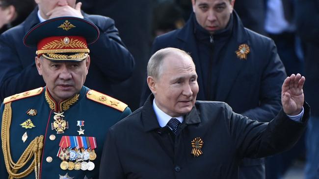 Vladimir Putin and Defence Minister Sergei Shoigu leave Red Square on Monday. Picture: AFP