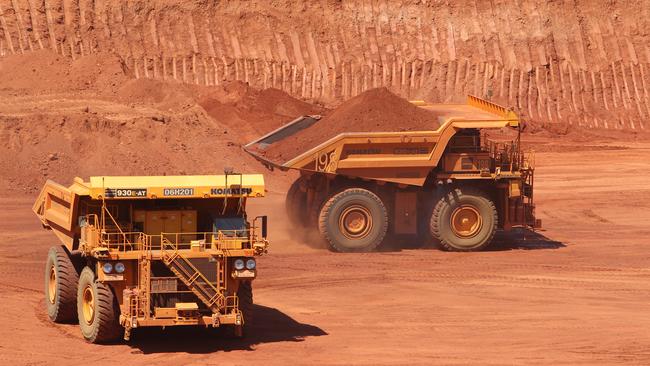 Driverless trucks loaded with ore at Rio Tinto's West Angelas Mine in Pilbara region of Western Australia.