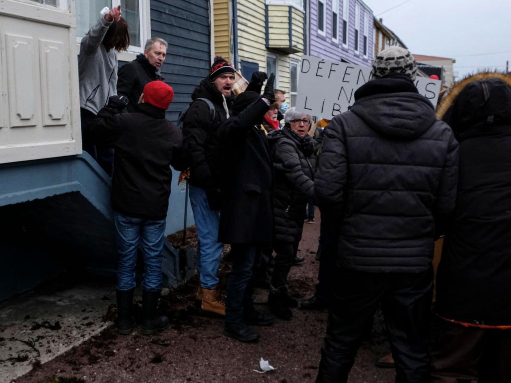 French MP Stephane Claireaux (L) argues with protesters who gather outside his home in Newfoundland for a demonstration against Covid restrictions and the health and vaccine pass. Picture: AFP