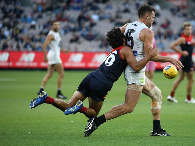 Jeff Garlett, seen here tackling Docherty, has been a success at the Dees. Picture: Wayne Ludbey