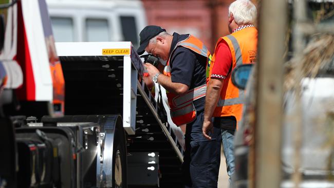 Police examine the accident site at Dry Creek. Picture: Tait Schmaal