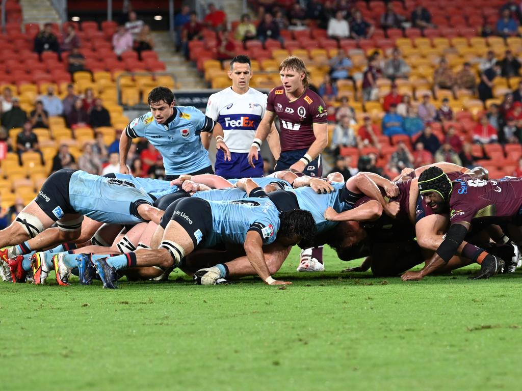 Reds halfback Tate McDermott (centre) stands over a scrum during his side’s win over the Waratahs at Suncorp Stadium. Picture: Dan Peled/Getty Images