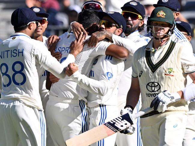 India's Viral Kohli gives a hug to paceman Jasprit Bumrah for his wicket of Australiaâs Steve Smith (R) during the first day of the first Test cricket match between Australia and India at the Optus Stadium in Perth on November 22, 2024. (Photo by SAEED KHAN / AFP) / -- IMAGE RESTRICTED TO EDITORIAL USE - STRICTLY NO COMMERCIAL USE --