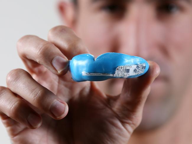 Mouthguard sports revolution. Ex north Melbourne defender Michael Firrito with the new microchipped mouthguard developed in Australia touted to be the future of concussion detection  . Pic: Michael Klein