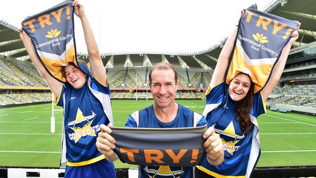 Queensland Country Bank CEO Aaron Newman (middle) with Cowboys supporters Kai Simmons, 17, and Victoria Fowler, 18, in their flip jerseys. Picture: Shae Beplate.