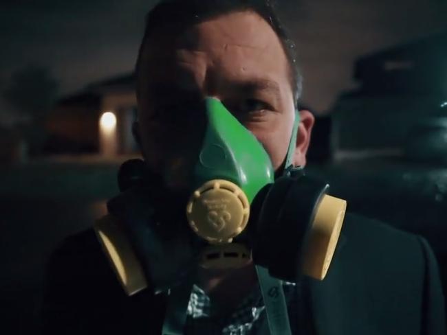 Mr Goldwasser dons a gas mask in the dramatic video.