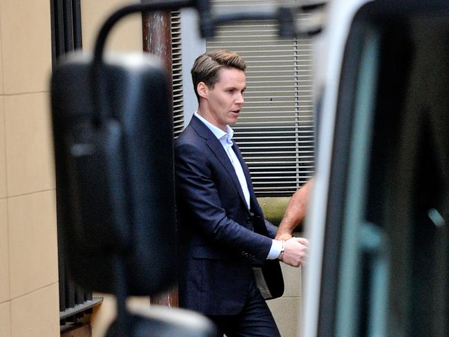 Stockbroker Oliver Curtis is escorted to a prison van at the Supreme Court two weeks ago after sentencing.