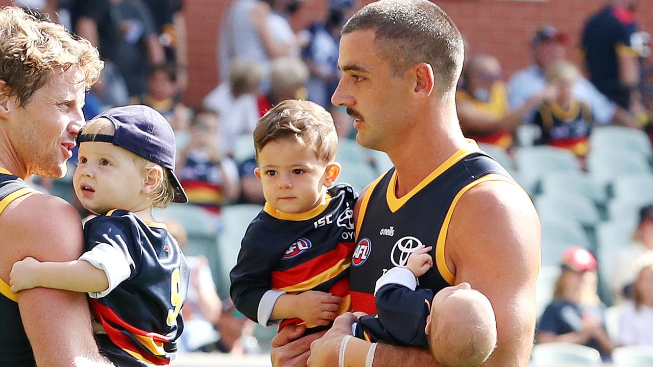 Rory Sloane and Walker proudly carried their children onto Adelaide Oval before their Round 1 match against Geelong on Saturday. Picture: AFL Photos/Getty Images