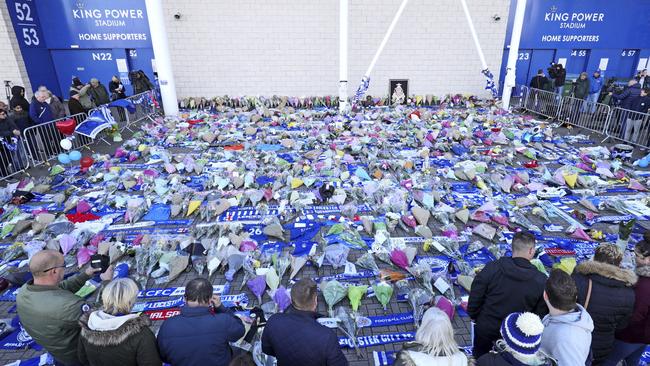 Supporters pay tribute to Vichai Srivaddhanaprabha outside Leicester City Football Club.