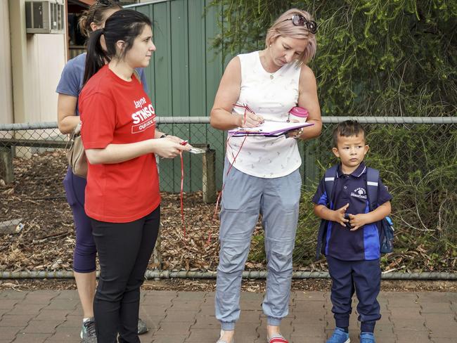 Angry parents sign a petition outside the Black Forest Primary School. Picture: AAP/MIKE BURTON