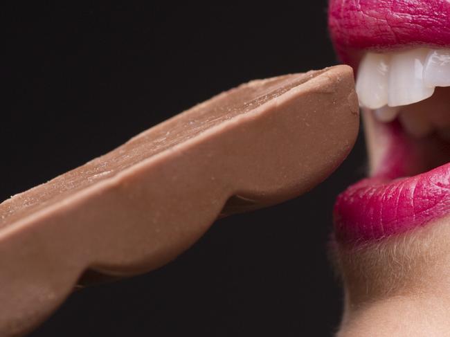 Young Woman Eating Chocolate