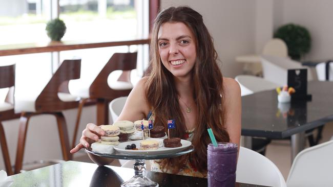 Mucho Love is a newly opened South American cafe at Edge Hill, specialising in Argentinian treats and Peruvian coffee. Mucho Love co owner Micaela Lukac with Argentinian biscuits alfajores, gluten free spinach crepe and a fresh berry smoothie. Picture: Brendan Radke