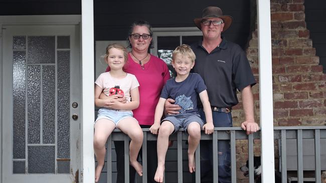 Jennifer and Jason Nixon with their two children Amber, 7, and Hunter, 5, on their property in Glen Huon that was spared from the bushfires that swept through the region. Picture: LUKE BOWDEN