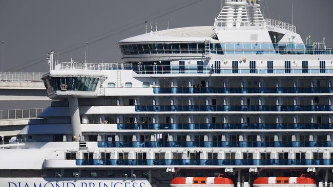 Passengers stand on balconies on the Diamond Princess cruise ship. Picture: Charly Triballeau/AFP.