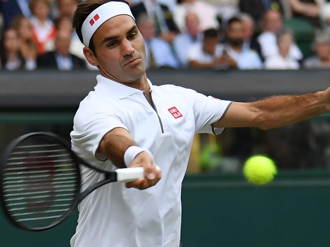 Switzerland's Roger Federer returns against Italy's Matteo Berrettini during their men's singles fourth round match on the seventh day of the 2019 Wimbledon Championships at The All England Lawn Tennis Club in Wimbledon, southwest London, on July 8, 2019. (Photo by Ben STANSALL / AFP) / RESTRICTED TO EDITORIAL USE