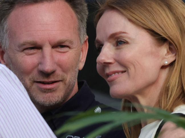 Red Bull Racing team principal Christian Horner and his wife British singer Geri Halliwell talk to an acquaintance ahead of the Bahrain Formula One Grand Prix at the Bahrain International Circuit in Sakhir on March 2, 2024. (Photo by Giuseppe CACACE / AFP)