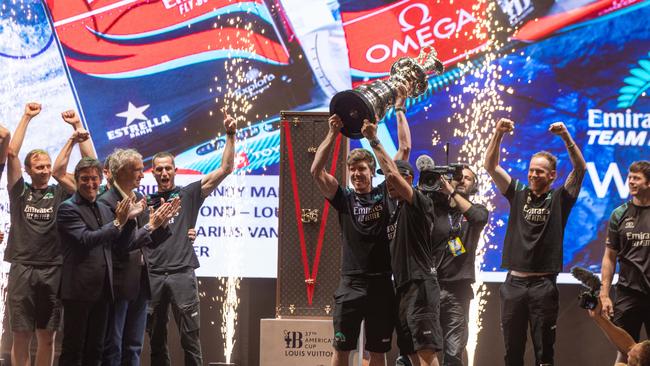 LVMH chairman and chief executive Bernard Arnault and Louis Vuitton chairman and chief executive Pietro Beccari present the Auld Mug to the Emirates Team New Zealand team in Barcelona.