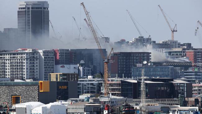 The smoke and fire are still visible from under the Auckland Harbour Bridge on October 23, 2019 in Auckland, New Zealand. (Photo by Fiona Goodall/Getty Images)