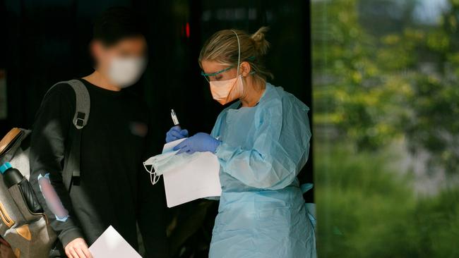 Patient in mask been seen by triage nurse at Northern Beaches Hospital's new COVID-19 clinic. Picture: Tim Pascoe