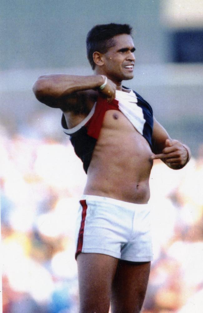 Footballer Nicky Winmar lifts his guernsey and pointing to his skin says "I'm black and I'm proud" to jeering Collingwood fans 26 Apr 1993.